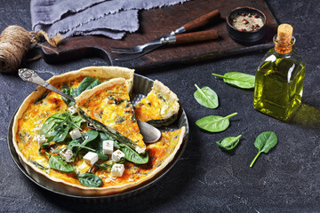 feta spinach parmesan quiche in a baking dish