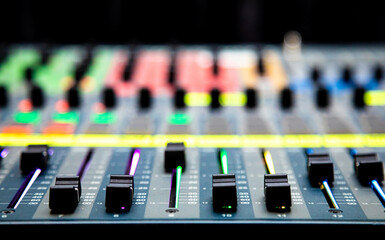 Sliders and buttons on Audio Mixing Desk at live event.