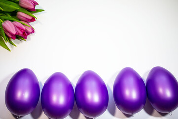 Easter eggs with tulips on a white background