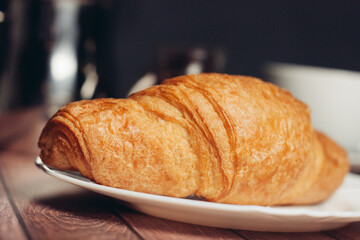 fresh croissants on a plate on the table breakfast dessert