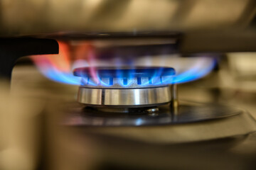 Combustion of household gas on a gas stove, gas energy saving concept.