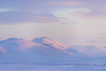 Winter arctic landscape. Beautiful morning view of the snow-capped mountains. Cold frosty weather. Amazing northern nature. Travel to the Arctic. Chukotka, Polar Siberia, the Far North of Russia.