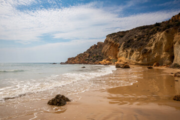 View of the Le Pergole beach in Sicily. The colorful rocks contrast beautifully with the color of the sea. A warm summer afternoon.