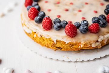 heart love carrot cake mothersday, valentines day, wedding cake with blueberries, raspberries, and heart sprinkles 