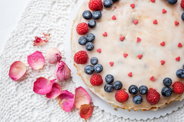 heart love carrot cake mothersday, valentines day, wedding cake with blueberries, raspberries, and heart sprinkles 