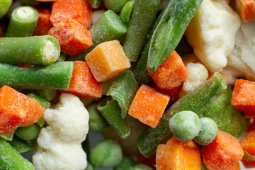 Frozen vegetables close-up carrots peas pod