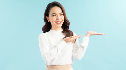 Pretty lady with casual dress looking camera with smile in studio advertising for product