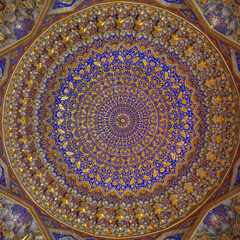 Beautiful gold and blue decor on ceiling of ancient Tilya Kori madrassa on Registan square in UNESCO listed Samarkand, Uzbekistan