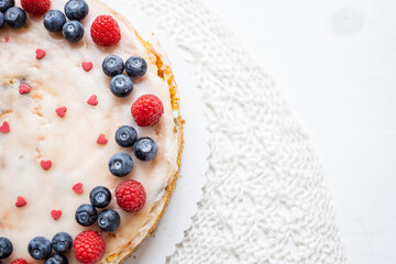 heart love carrot cake mothersday, valentines day, wedding cake with blueberries, raspberries, and heart sprinkles 