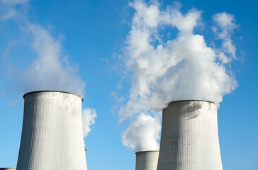 Obraz premium Smoking chimneys against the blue sky, environmental pollution concept.