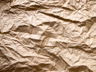 Abstract background made of recycled paper. Beige brown crumpled kraft paper. Ecological concept. Copy space.