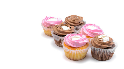 Chocolate and vanilla cupcakes with whipped raspberry and coffee cream, on a white isolated background. Selective focus.