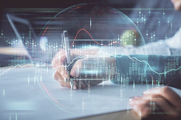 Double exposure of forex chart drawing over people taking notes background. Concept of financial analysis
