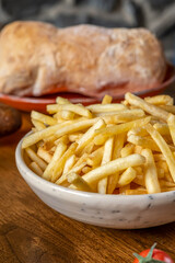 Fried french potatoes. Enjoying tasty vegan food with friends in restaurant. Selective focus