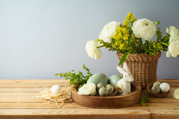 Easter holiday concept with beautiful flowers bouquet and Easter eggs on wooden table
