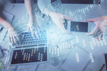 Multi exposure of man and woman working together and forex graph hologram drawing. Financial analysis concept. Computer background. Top View.