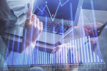 Double exposure of man and woman working together and forex chart hologram. Business concept. Computer background.