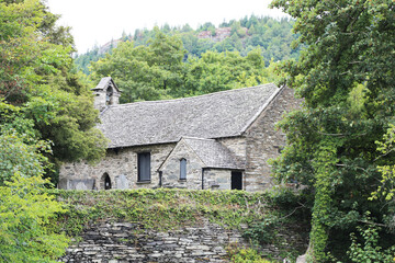Fototapeta na wymiar A church on the banks of the River Conwy at Betws-y-Coed, Wales, UK.