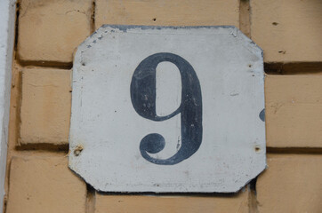Schild mit einer Hausnummer -neun -9