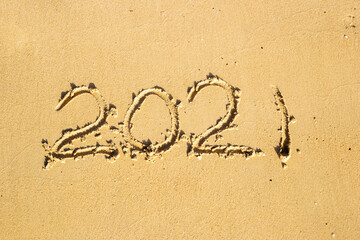 2012 figures written by hand on the sand of the beach.
