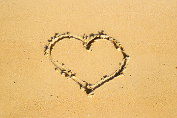 hand drawn heart symbol on the sand of the beach. Summer holidays, love.