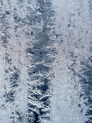 Ice crystals in the detail on a window glass in winter time