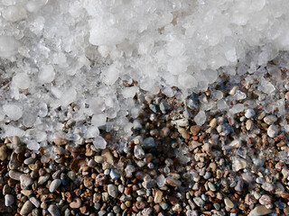 ice over pebble stones. top down view.