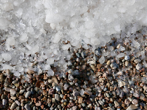 Ice Over Pebble Stones. Top Down View.