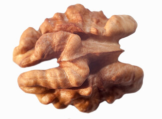 half a peeled walnut on a white background