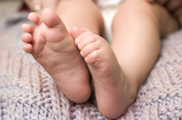 small pink feet of the baby close up