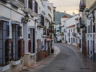 old town of nerja with narrow streets and typical architecture with many balconies and plants...