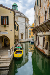 Venice canal, a green water surrounded by buildings