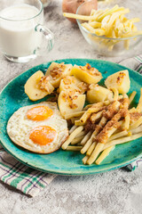 Fried eggs with boiled potatoes and yellow string beans