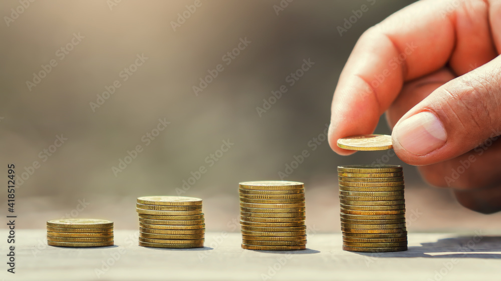 Poster saving money hand putting coins on stack on table with sunshine. concept finance and accounting