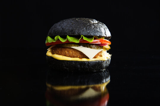 Delicious Fast Food. Modern Black Burger On Black Bacground.