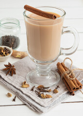 A glass of hot Indian masala tea brewed with aromatic spices and milk