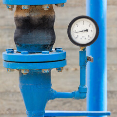 Manometer on blue pipe