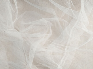 White mosquito net fabric texture with folds. Wavy chiffon background. Full frame of crumpled white...