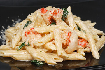 Penne Pasta. Pasta with grilled shrimp marinara sauce, Parmesan cheese and fresh Italian parsley.