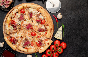 delicious meat pizza on a stone background with copy space for your text