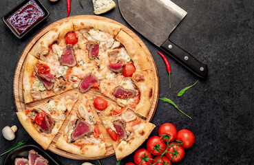 delicious meat pizza on a stone background with copy space for your text