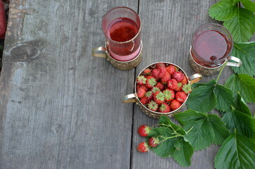 Berry strawberry tea and fresh garden strawberries on wooden background