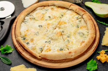 four cheese pizza with ingredients on stone background