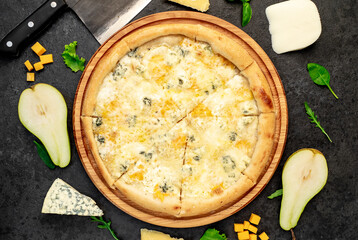 four cheese pizza with ingredients on stone background