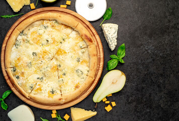 four cheese pizza with ingredients on stone background with copy space for your text