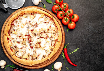 pizza with chicken, mushrooms and pineapple on a stone background  with copy space for your text