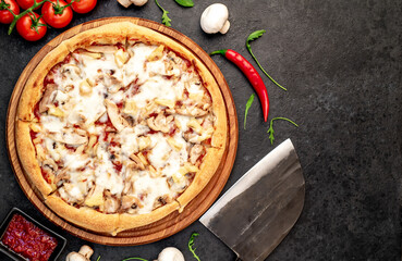 pizza with chicken, mushrooms and pineapple on a stone background with copy space for your text