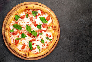 Pizza Margherita on a stone background with copy space for your text