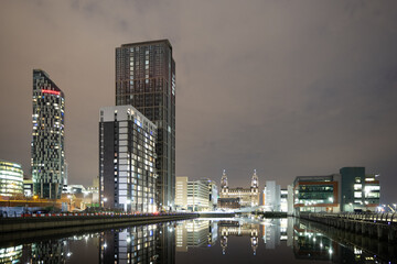 Fototapeta na wymiar The skyline of Liverpool shines bright at night