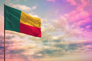 Fluttering Benin flag mockup with the space for your content on colorful cloudy sky background.